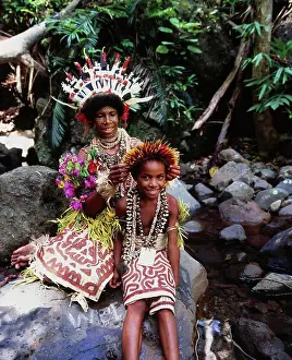 Adjusting Prints: Young girl and woman in traditional dress from PNG's Oro Province; Papua New Guinea