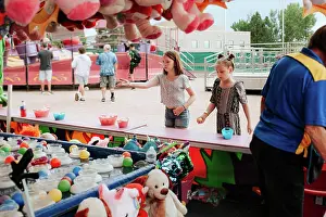 Gradeschooler Prints: Two young girls playing a carnival game