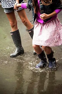 Out Door Prints: Two Young Girls Walking Through Puddle in Rubber Boots