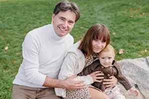 Small Group Prints: Young italian man, toddler boy and teenage daughter hugging outdoors