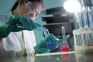 Toxic Prints: Young laboratorian carries chemical experiments Young laboratorian carries chemical experiments in laboratory Copyright