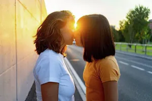 20 To 25 Years Prints: Young lesbian couple kissing during sunset