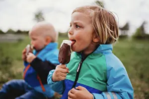 1 2 Years Old Prints: Young male kids looking to side licking chocolate popsicle ice cream