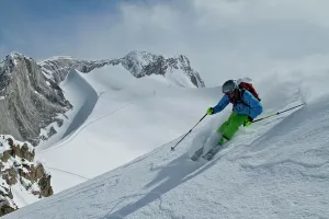 Creek Prints: Young male skier skis untracked powder at Chatter Creek Catskiing, near Golden, BC, Canada