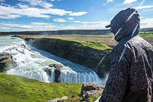 Icelandic Prints: A young man above the Gullfoss waterfall in the golden circle of the south of Iceland