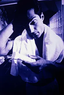 Hands Behind Head Prints: Young man holding a pill bottle