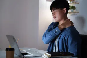 Desk Prints: Young man overtime work and feel shoulder and neck pain at home