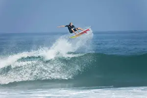 A young man performing an aerial maneuver at Rocky Point, north shore of Oahu