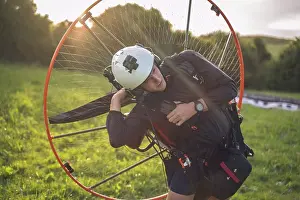 Heaven Prints: Young man, with the Powered Paragliding engine in his shoulders