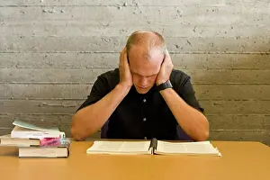 Difficult Prints: Young man reading and studying in a library
