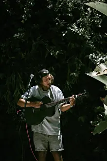 Expressive Prints: Young man singer, sings into a microphone and plays the guitar