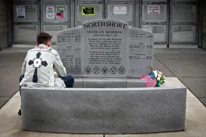 Memorials Prints: Young man sits in contemplation at an America war veterans memorial; Bothell