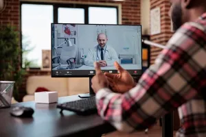 Video Prints: Young man talking to doctor on videocall
