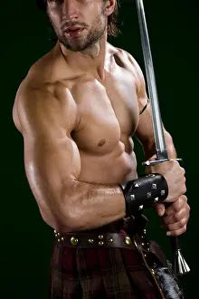 Macho Prints: Young man in warrior costume holding a sword
