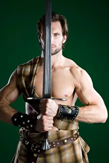 Macho Prints: Young man in warrior costume holding a sword