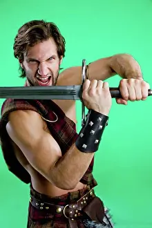 Macho Prints: Young man in warrior costume holding a sword
