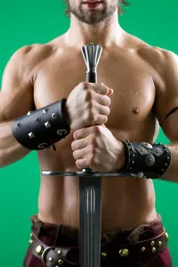 : Young man in warrior costume holding a sword