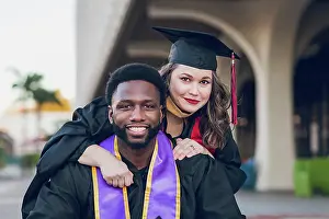 Scholar Prints: Young man & woman graduating college, wearing a graduation gown/cap