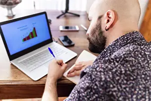 Bald Prints: Young man working on laptop at home