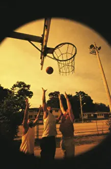 Agility Prints: Three young men playing basketball