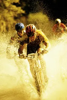 Biking Prints: Young men riding bicycles through water