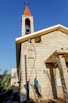 Catholic Prints: Young men ringing the bell of St. Elias maronite church, Bdadoun, Lebanon