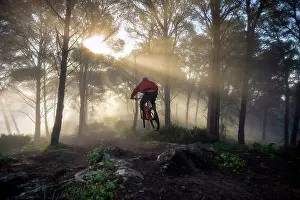 Jump Prints: Young mountain biker jumps in a beatiful foggy morning. Spain