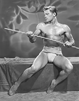 Bodybuilder Prints: Young Nude Bodybuilder Seated with Cane c.1952