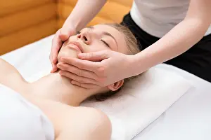 2016 Prints: Young pretty woman enjoying face massage procedure Young pretty woman enjoying face massage procedure in spa saloon