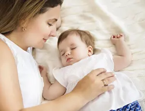 Doze Prints: Young pretty woman with sleeping baby girl