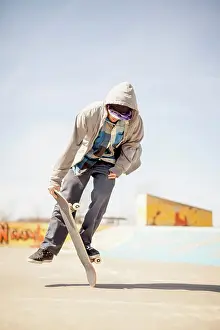 Skate Prints: Young skateboard enthusiast doing old school tricks