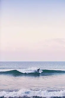 Wetsuit Prints: A young surfer off the coast of Portugal on an early January morning