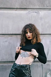 Designs Prints: Young tattooed woman posing sensual in the street