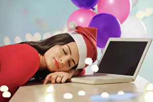 Occasion Prints: Young woman asleep on her desk after office party