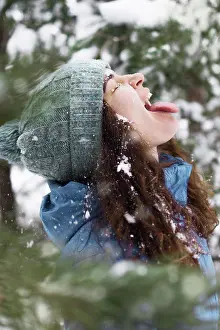 Recreation Prints: A young woman catches snow, sticking out her tongue, closes her eyes