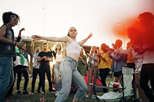 Frgbild Prints: Young woman dancing while friends enjoying in musical event during summer