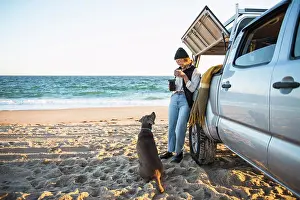 Hood Prints: Young woman and her dog while beach car camping alone