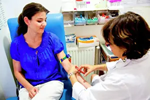 Brown Haired Prints: Young woman having a blood sample