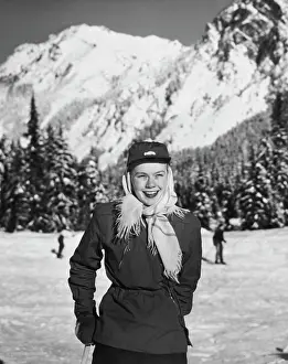 Covering Prints: Young woman holding a ski pole and smiling, Cascade Range, Washington, USA