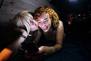 Reclining Prints: Young woman kissing her partner