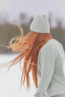 Sweater Prints: Young woman with long red hair wearing knit hat and sweater against clear sky