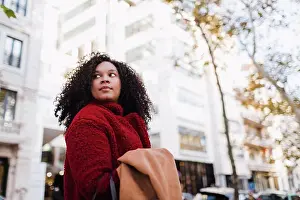 Turning Prints: Young woman looking over shoulder on urban street