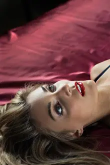 Bedroom Prints: Young woman lying on the bed and day dreaming