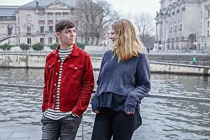 Guys Prints: young woman and man hanging out by the river Spree in Berlin