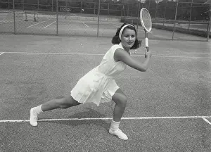 One Young Woman Only Prints: Young woman playing tennis on a tennis court