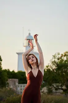 Gorgeous Prints: Young woman poses in a maroon dress at the Santa Pola Lighthouse