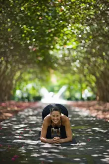 Shade Prints: Young woman practicing yoga in park