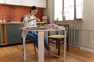 Smart Prints: Young woman preparing for exam in kitchen