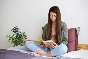 Calm Prints: Young woman reading book at home. Slow life