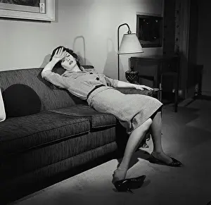 One Young Woman Only Prints: Young woman resting on a couch